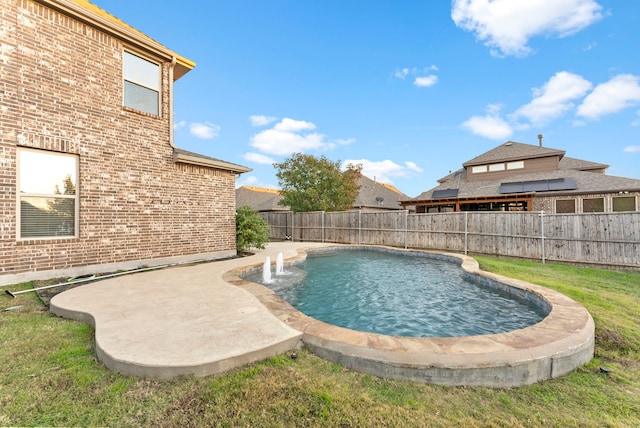 view of swimming pool with pool water feature and a patio area