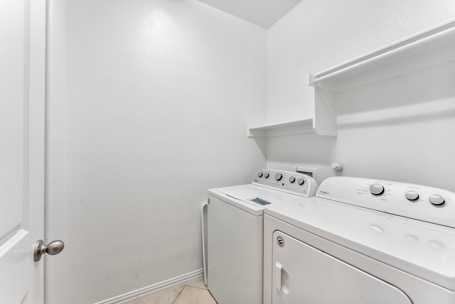 laundry area with light tile patterned flooring and washing machine and dryer