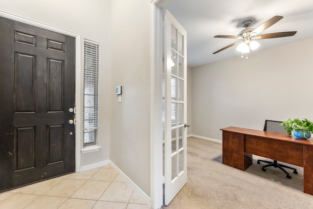 carpeted foyer featuring french doors and ceiling fan