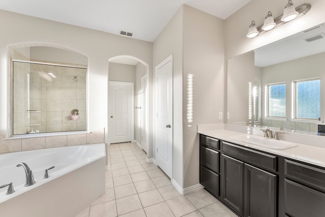 bathroom featuring tile patterned floors, separate shower and tub, and vanity