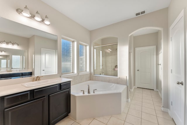 bathroom with tile patterned flooring, vanity, and independent shower and bath