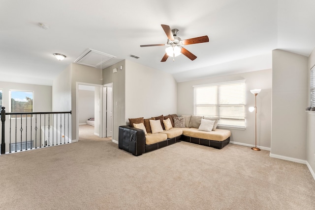 living room with ceiling fan, light colored carpet, a healthy amount of sunlight, and lofted ceiling