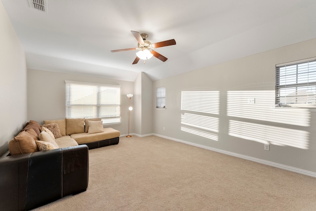 living room with light colored carpet, vaulted ceiling, a wealth of natural light, and ceiling fan