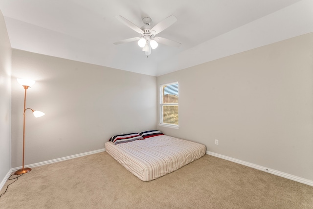 bedroom featuring light carpet and ceiling fan