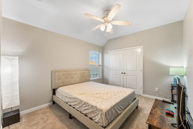 carpeted bedroom featuring a closet, vaulted ceiling, and ceiling fan