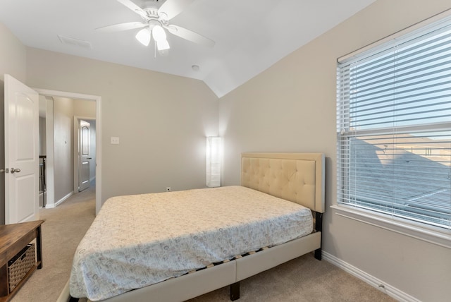 carpeted bedroom featuring ceiling fan and vaulted ceiling