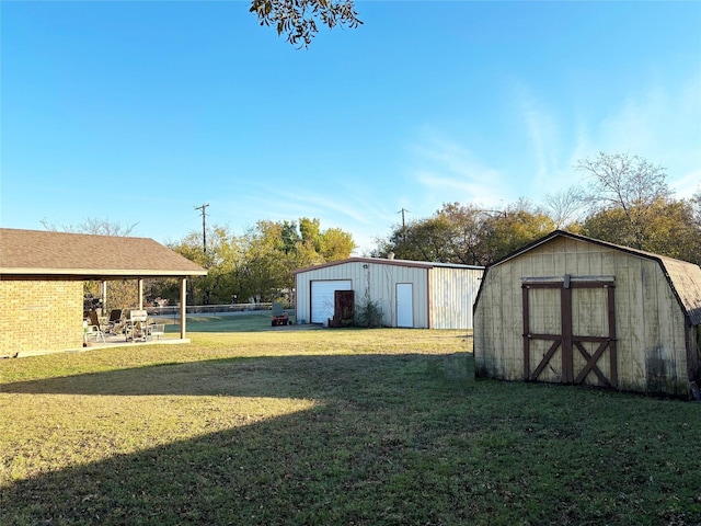 view of yard with a patio area and an outbuilding