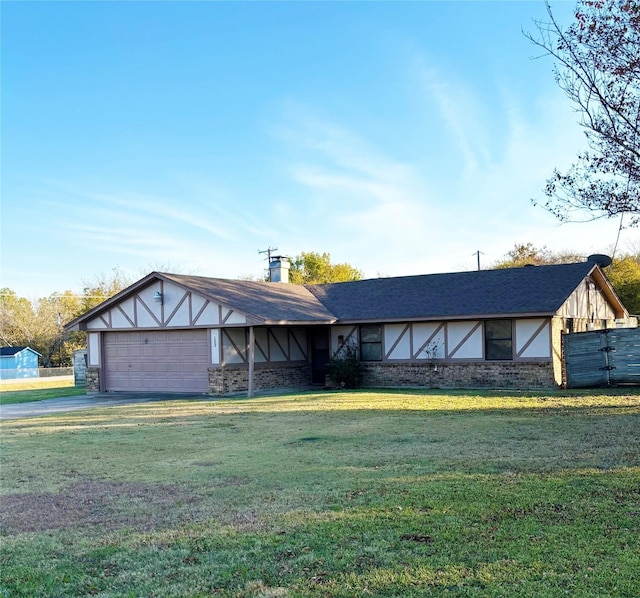 view of front of house with a garage and a front yard