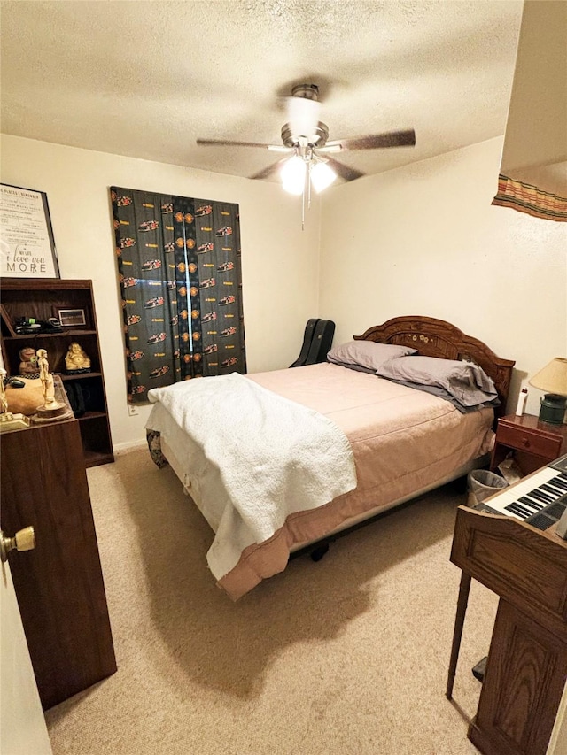 carpeted bedroom with ceiling fan and a textured ceiling