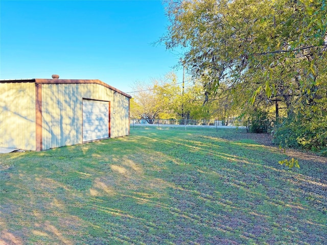 view of yard with a garage and an outdoor structure