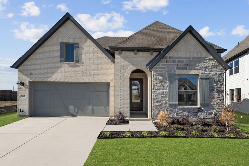 french country home with a garage and a front lawn