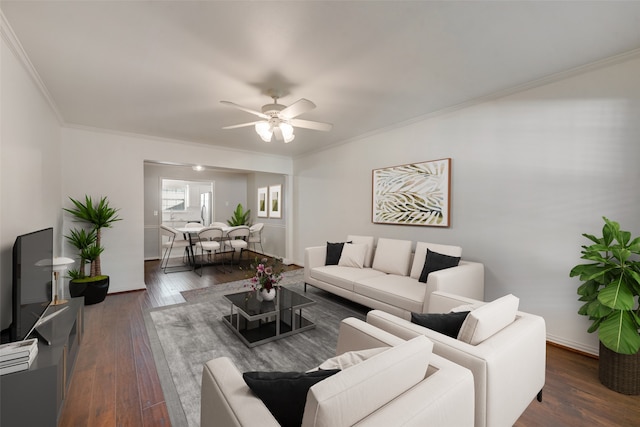 living room featuring crown molding, ceiling fan, and dark hardwood / wood-style floors