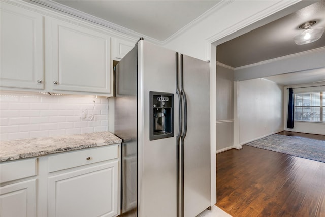 kitchen featuring light stone counters, ornamental molding, stainless steel fridge with ice dispenser, dark hardwood / wood-style floors, and white cabinetry