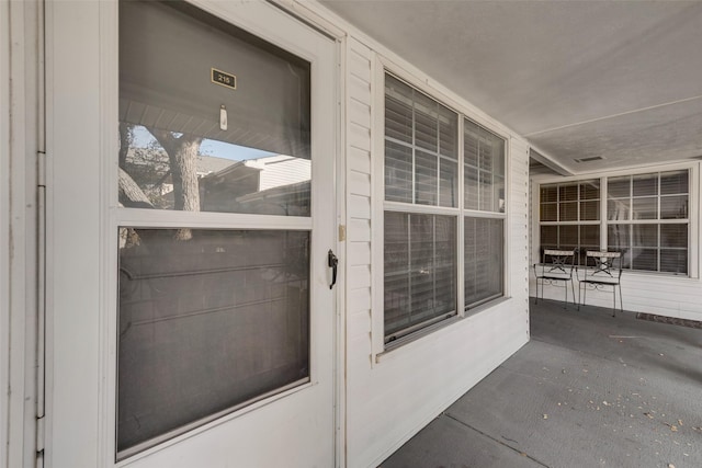 entrance to property featuring covered porch