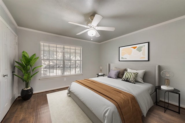 bedroom with a closet, dark hardwood / wood-style floors, ceiling fan, and crown molding