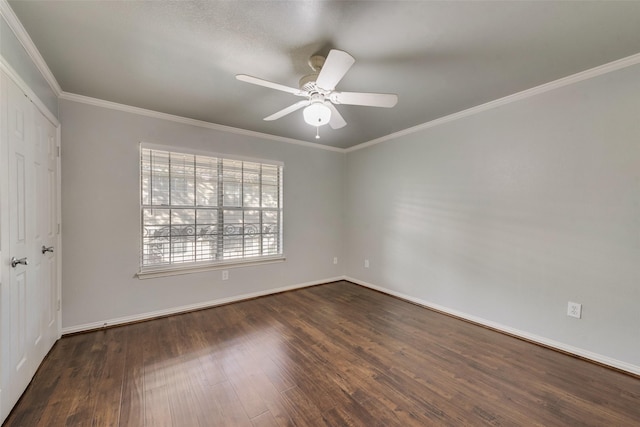 empty room featuring dark hardwood / wood-style floors, ceiling fan, and ornamental molding