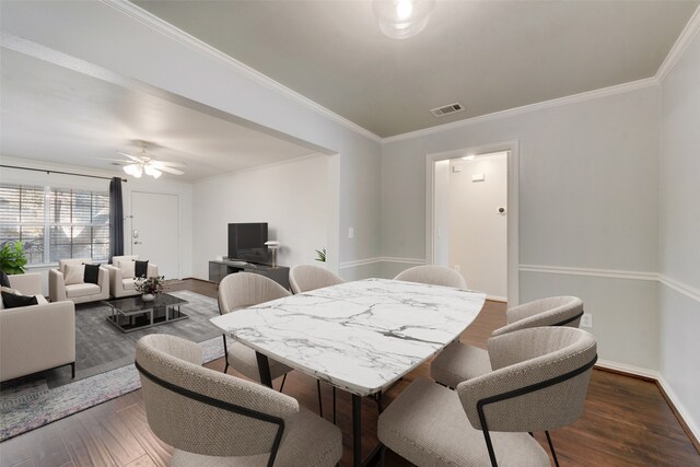 dining area with dark hardwood / wood-style floors, ceiling fan, and ornamental molding