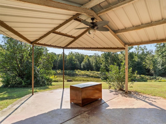 view of patio featuring a gazebo, ceiling fan, and a water view