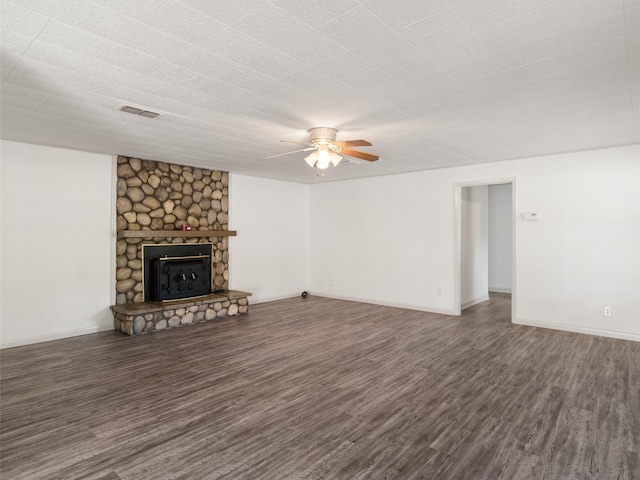 unfurnished living room featuring ceiling fan, a fireplace, and dark hardwood / wood-style floors