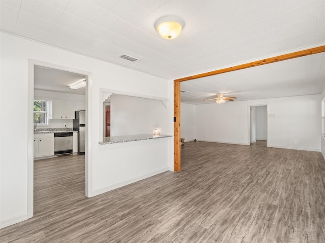 unfurnished living room with hardwood / wood-style floors and ceiling fan