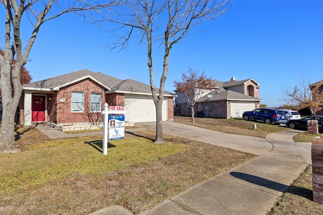 view of front of property featuring a garage and a front lawn