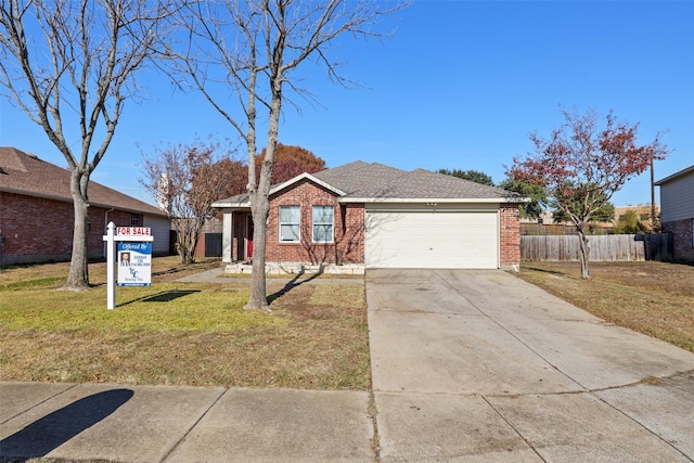 single story home with a garage and a front lawn