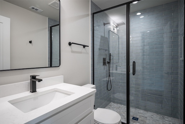 full bathroom with toilet, vanity, visible vents, and a shower stall