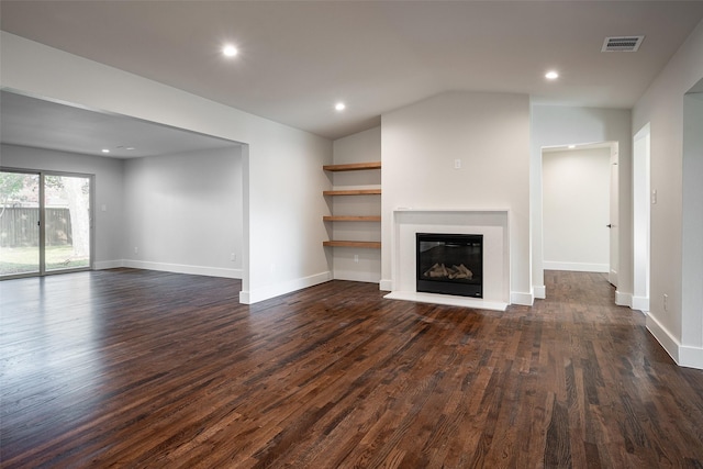 unfurnished living room featuring dark hardwood / wood-style flooring and vaulted ceiling