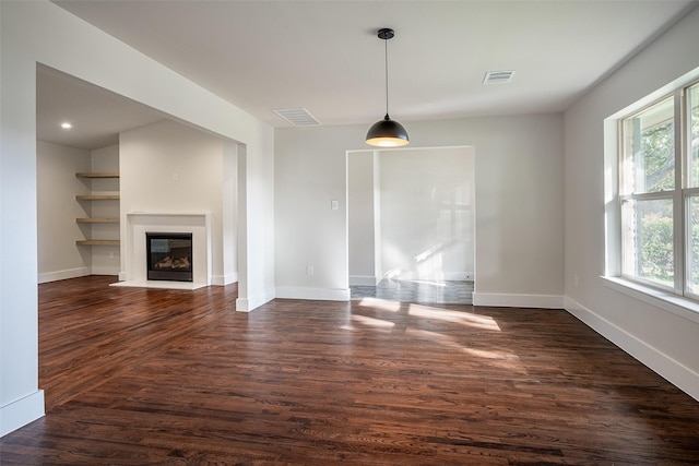 unfurnished living room with dark hardwood / wood-style floors