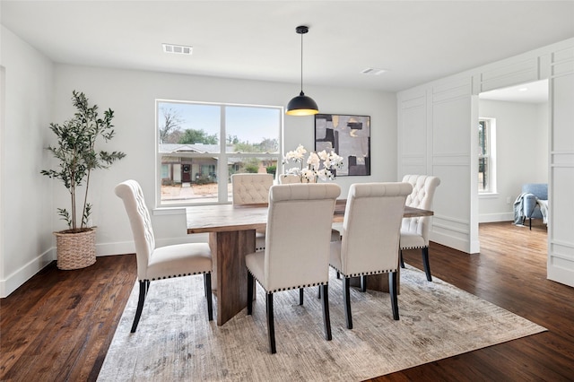 dining area featuring baseboards, visible vents, and dark wood-style flooring