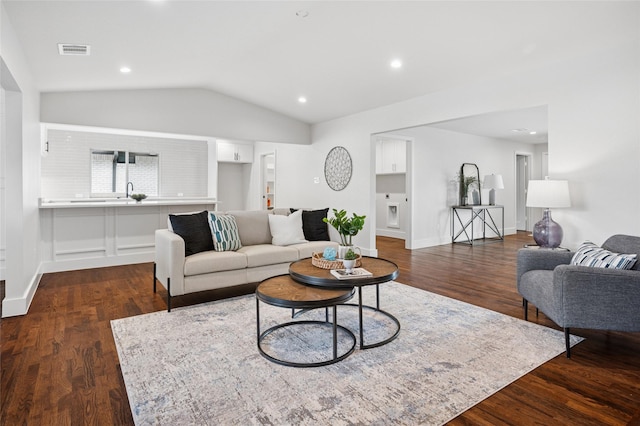 living area featuring dark wood-style floors, visible vents, vaulted ceiling, and recessed lighting