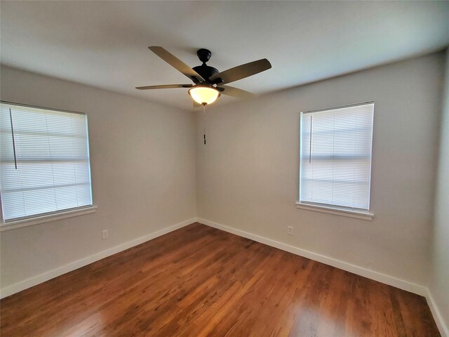 spare room with hardwood / wood-style floors and ceiling fan