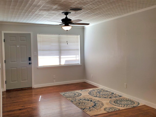 entryway with hardwood / wood-style floors, ceiling fan, and crown molding