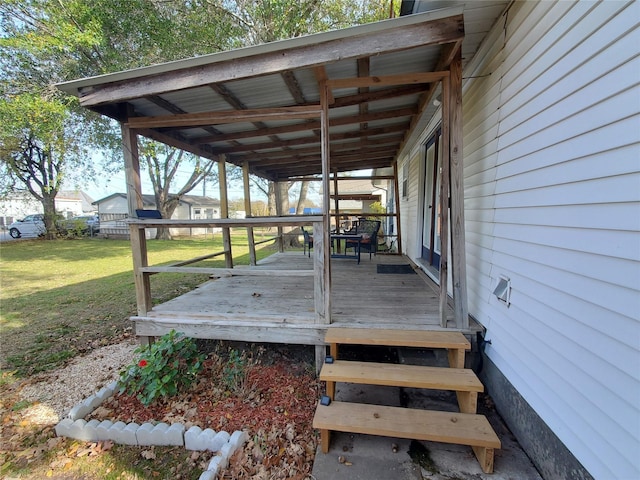 wooden deck featuring a lawn