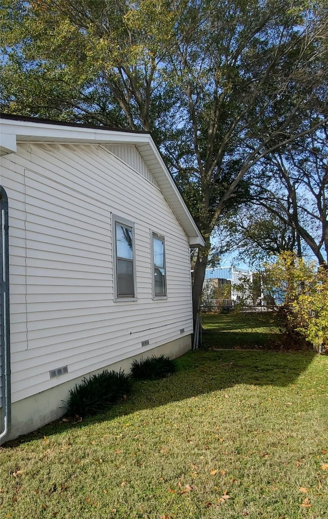 view of side of home featuring a yard