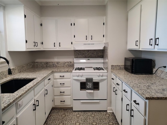 kitchen with white cabinetry, sink, light stone counters, and white stove