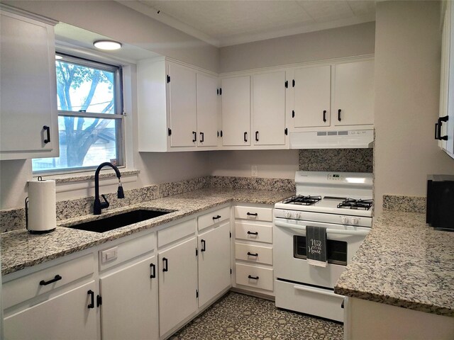 kitchen featuring white cabinets, extractor fan, and white gas range oven