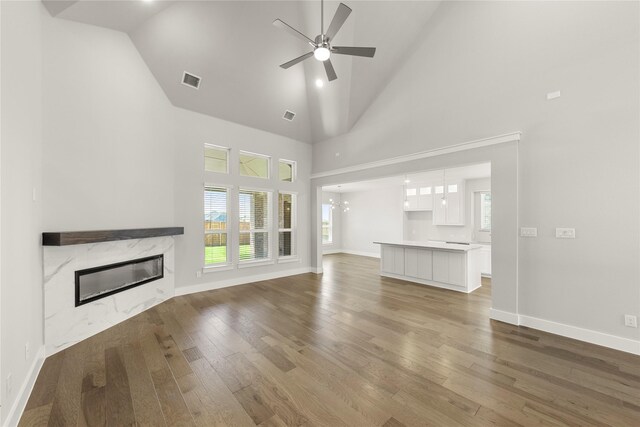 1347 Overton St, Frisco, TX 75036 - unfurnished living room featuring a fireplace, high vaulted ceiling, light wood-style flooring, ceiling fan, and baseboards