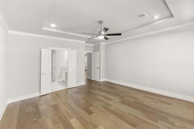 1347 Overton St, Frisco, TX 75036 - unfurnished bedroom with a tray ceiling, light wood-style floors, baseboards, ornamental molding, and recessed lighting