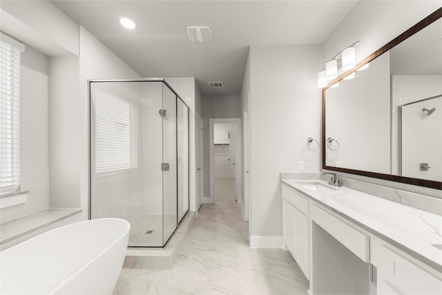 1347 Overton St, Frisco, TX 75036 - bathroom with a stall shower, marble finish flooring, a freestanding tub, vanity, and baseboards