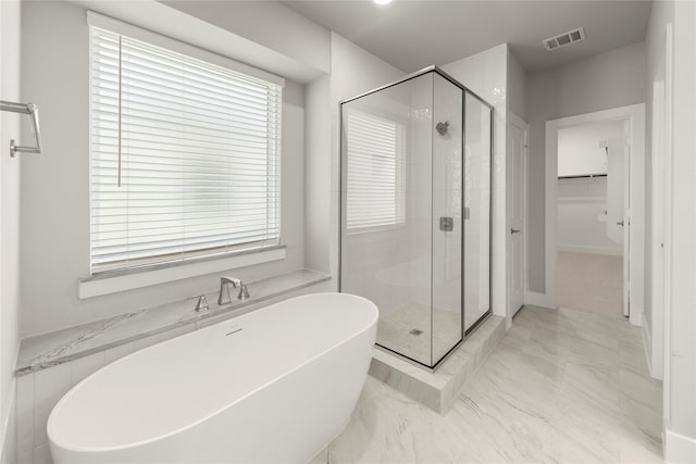 1347 Overton St, Frisco, TX 75036 - full bath featuring a stall shower, a soaking tub, a spacious closet, marble finish floors, and plenty of natural light