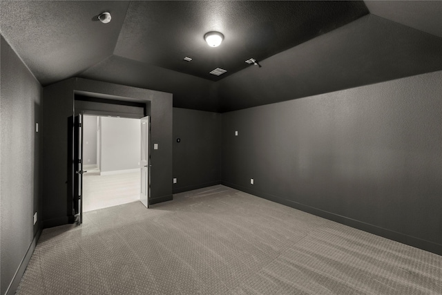1347 Overton St, Frisco, TX 75036 - spare room featuring carpet floors, lofted ceiling, baseboards, and a textured ceiling