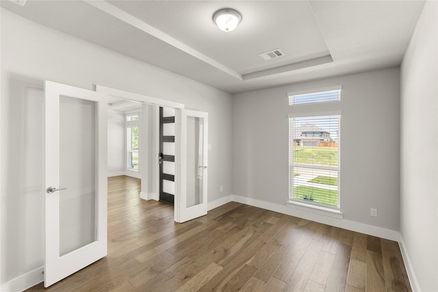 1347 Overton St, Frisco, TX 75036 - unfurnished room featuring french doors, plenty of natural light, and dark wood-style flooring