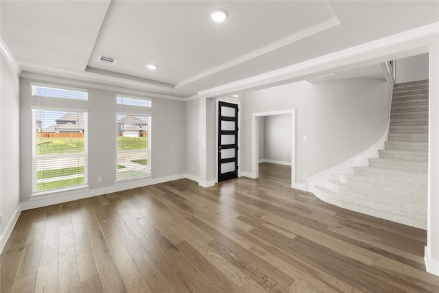 1347 Overton St, Frisco, TX 75036 - unfurnished living room featuring a raised ceiling, hardwood / wood-style flooring, baseboards, stairway, and recessed lighting