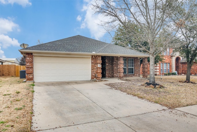 single story home featuring a garage and central AC unit