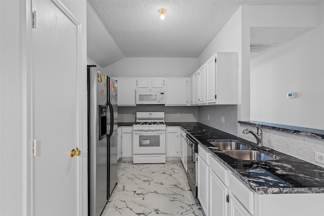 kitchen featuring decorative backsplash, white appliances, white cabinetry, and sink