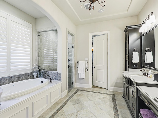 bathroom featuring separate shower and tub, vanity, and an inviting chandelier