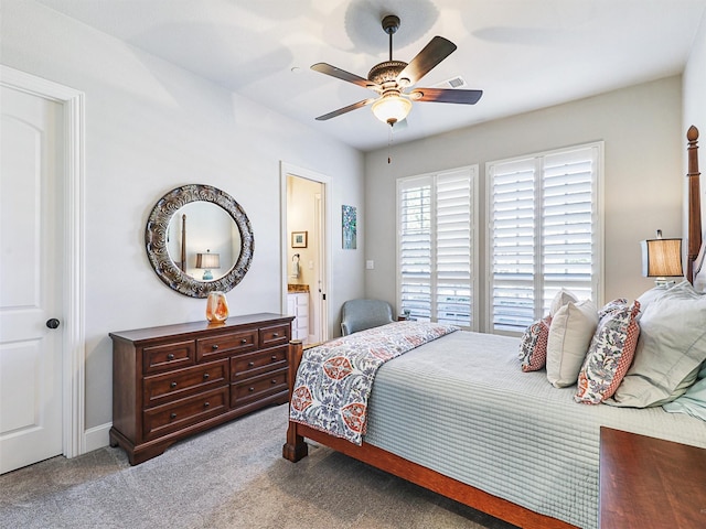 carpeted bedroom with ceiling fan and connected bathroom