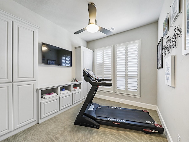 workout area with light carpet and ceiling fan