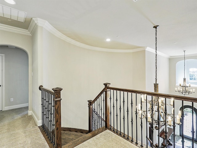 interior space with crown molding, a chandelier, and dark colored carpet